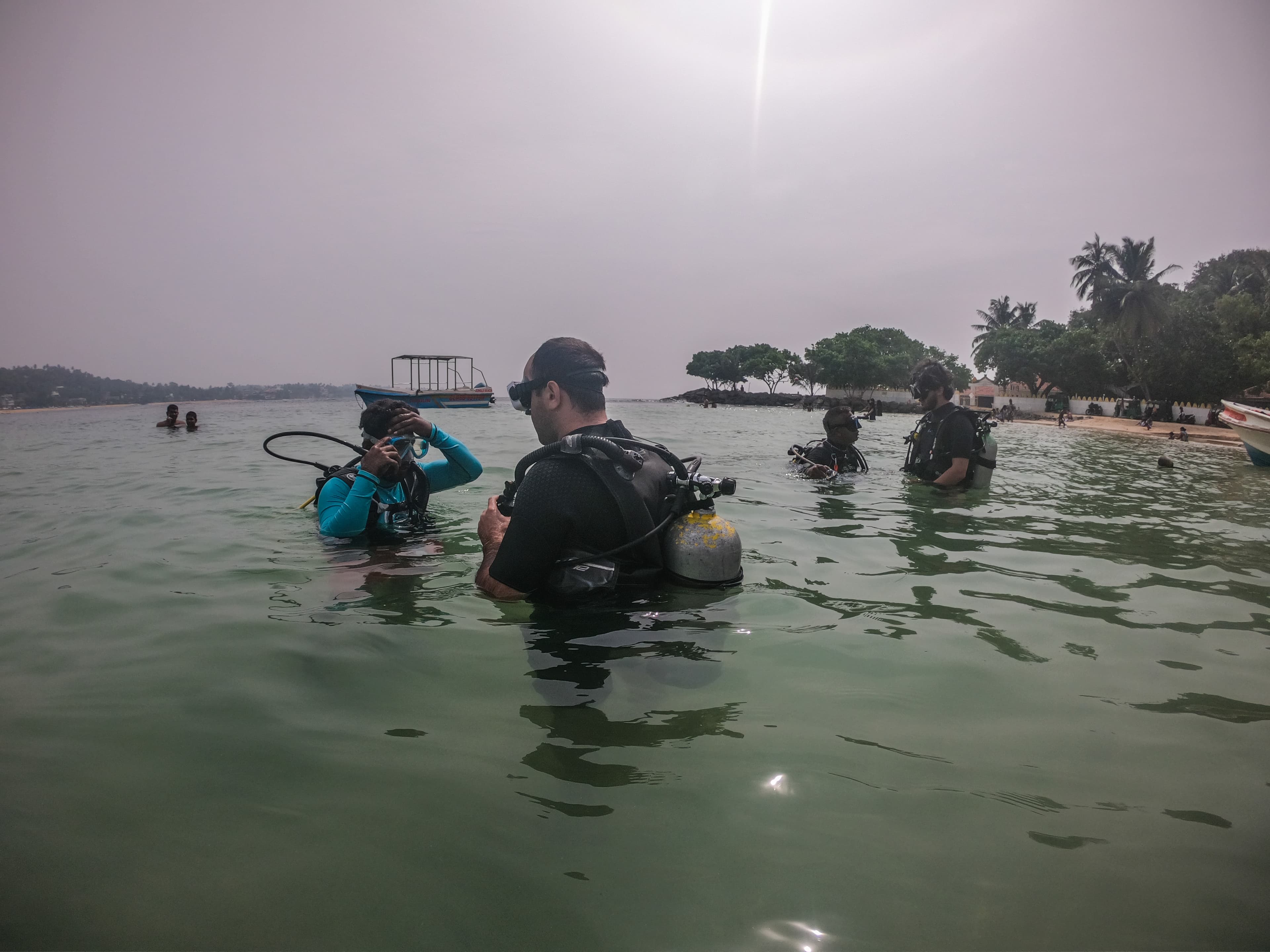 Instructor guiding a first-time diver in the shallow water off Unawatuna Beach