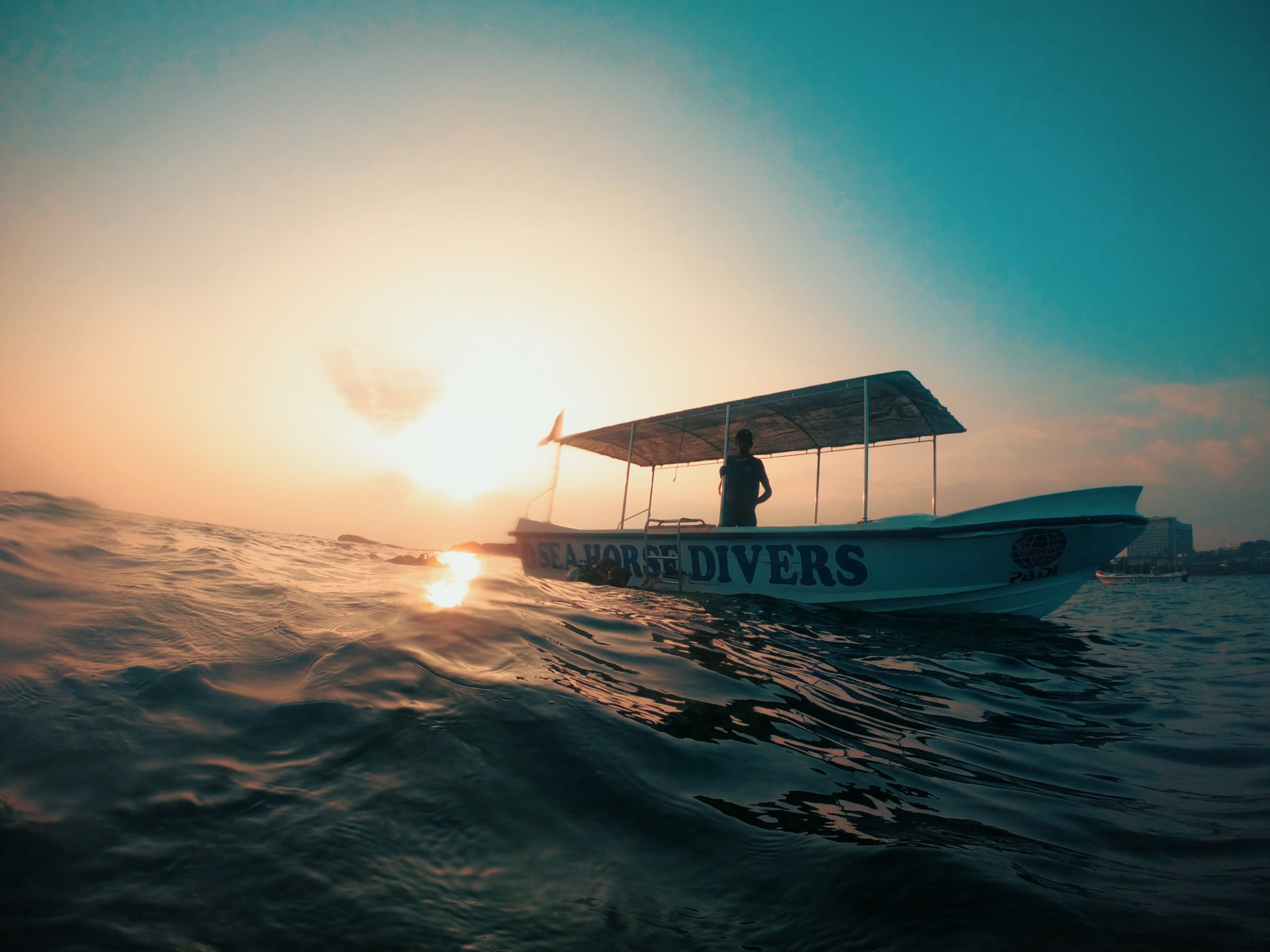 Seahorse Divers boat on the water off Unawatuna at sunset
